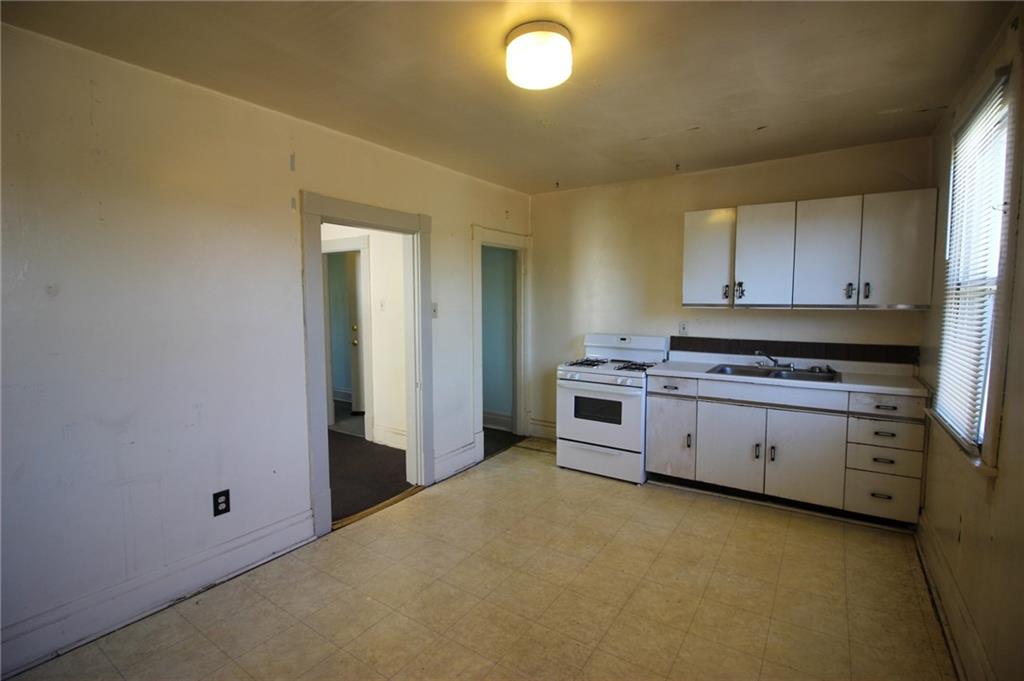 244 Center Street Springdale, PA 15144 - Photo 23 of 32 a kitchen with cabinets appliances and a window