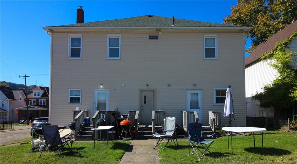 244 Center Street Springdale, PA 15144 - Photo 31 of 32 a front view of a house with a garden and patio