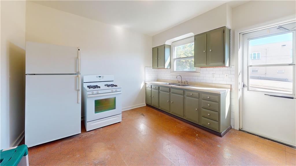 244 Center Street Springdale, PA 15144 - Photo 7 of 32 a kitchen with a stove top oven and sink