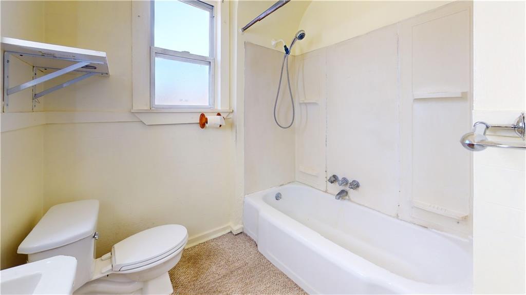 244 Center Street Springdale, PA 15144 - Photo 9 of 32 a white bath tub sitting next to a white toilet