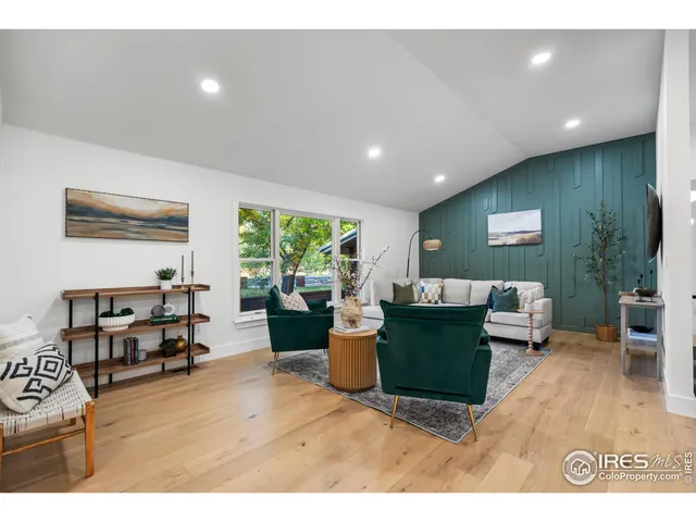 a living room with furniture window and wooden floor