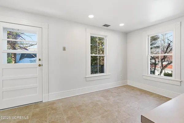 an empty room with windows and closet