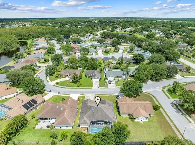 an aerial view of residential house with outdoor space and a lake view