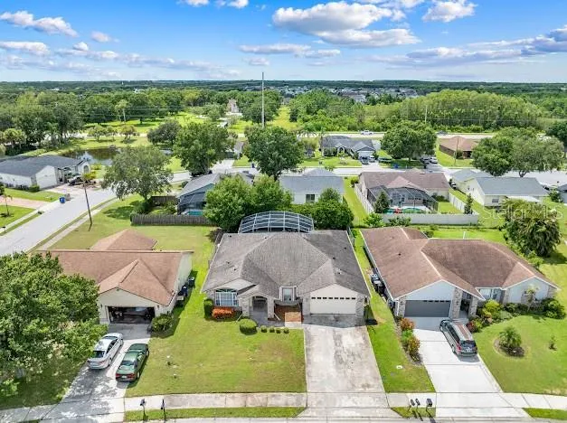 an aerial view of residential houses with outdoor space and lake view