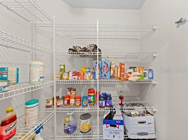 a store room with lots of clutter and cabinets