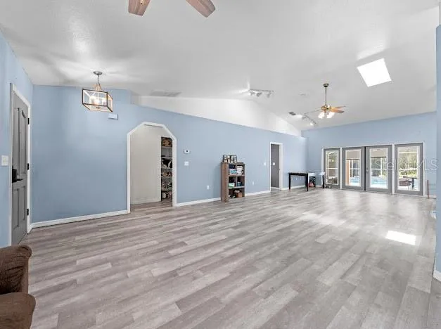 a view of a livingroom with a furniture chandelier and windows