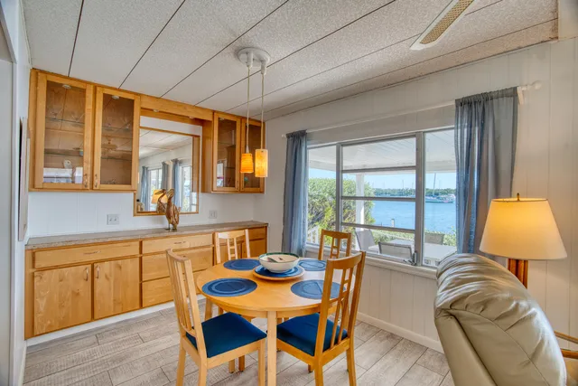 a dining room with furniture a chandelier and wooden floor