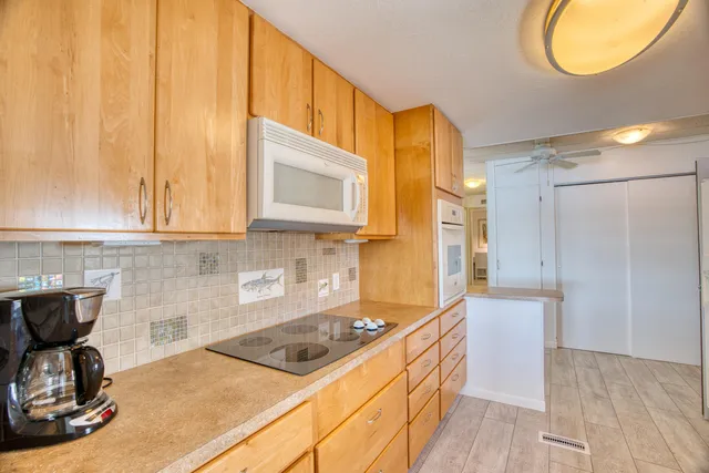 a kitchen with stainless steel appliances a refrigerator sink and microwave