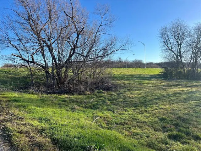 a view of a balcony with yard