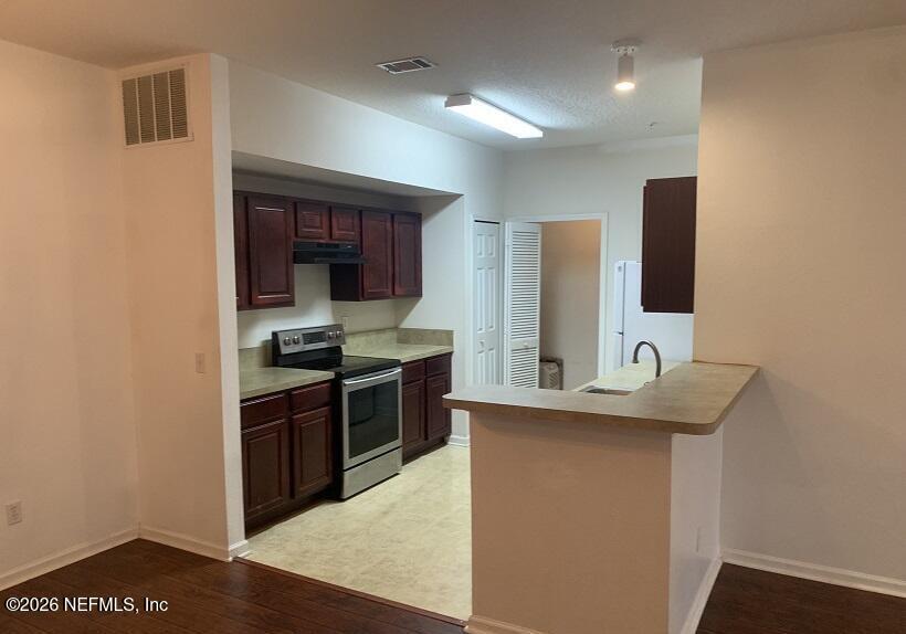 3631 Kirkpatrick Circle, Unit 6 Jacksonville, FL 32210 - Photo 4 of 14 a kitchen with stainless steel appliances granite countertop a sink stove and oven