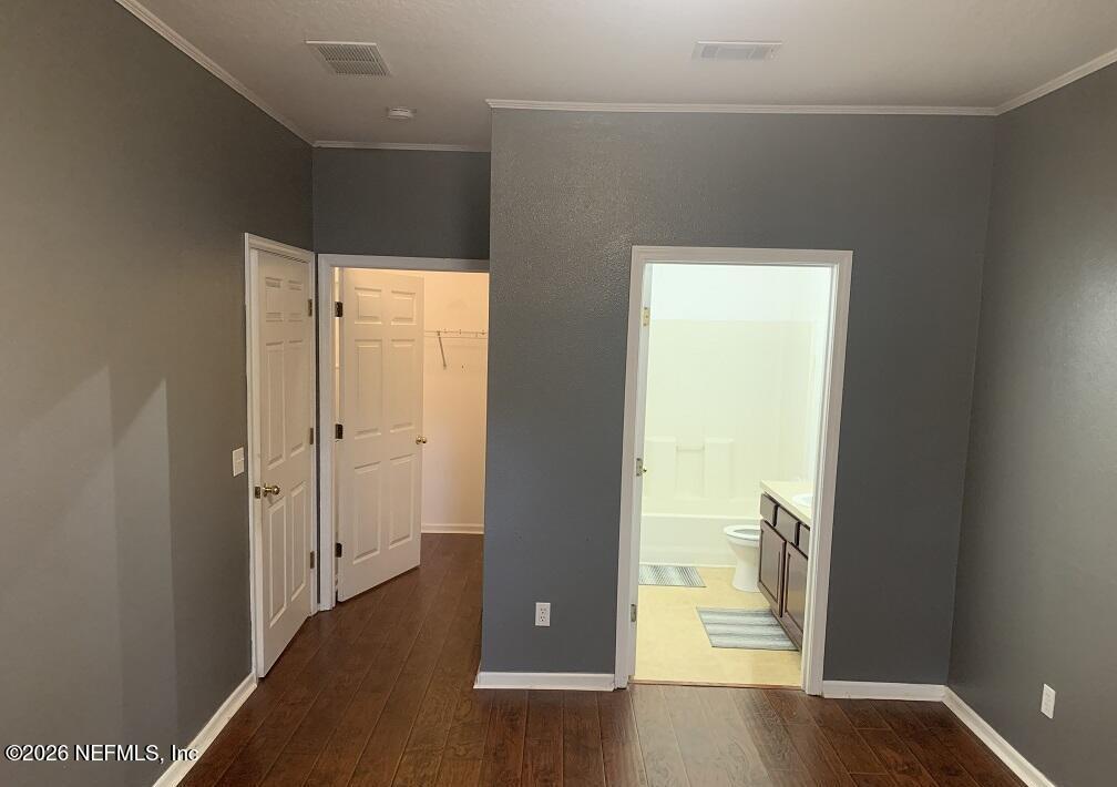 3631 Kirkpatrick Circle, Unit 6 Jacksonville, FL 32210 - Photo 6 of 14 an empty room with wooden floor and windows