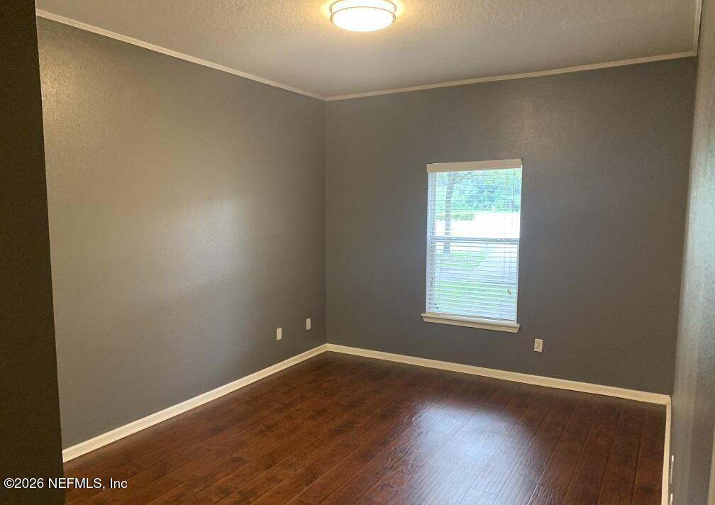 3631 Kirkpatrick Circle, Unit 6 Jacksonville, FL 32210 - Photo 7 of 14 an empty room with wooden floor and windows
