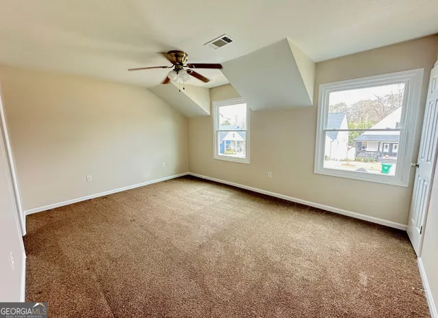 a bathroom with a granite countertop sink a mirror and shower