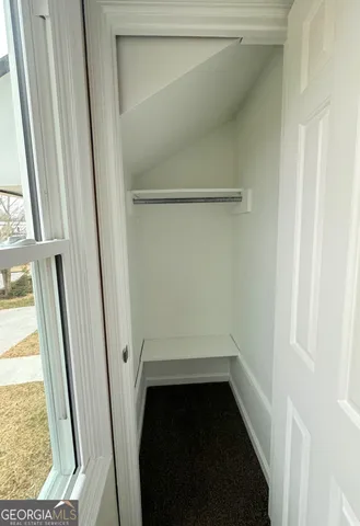 a bathroom with a sink a toilet a mirror and shower