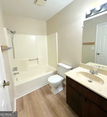 a view of a livingroom with a chandelier fan and windows