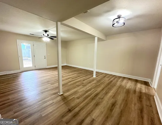a view of a room with wooden floor