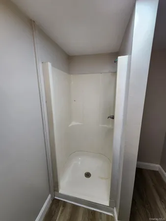 a bathroom with a glass shower door