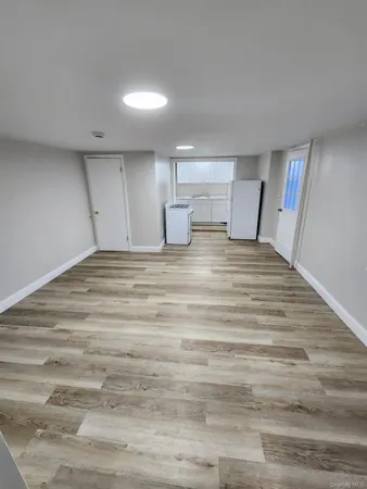a view of a room with wooden floor