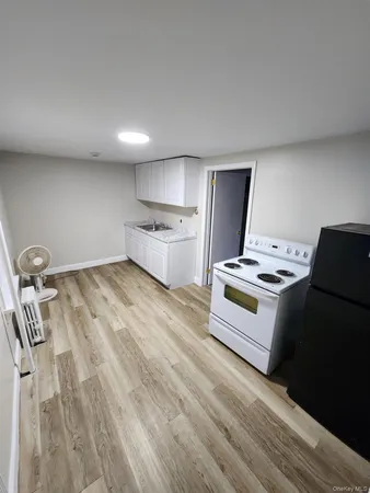a kitchen with kitchen island a stove a sink and a refrigerator