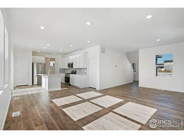 a view of kitchen and hall with wooden floor