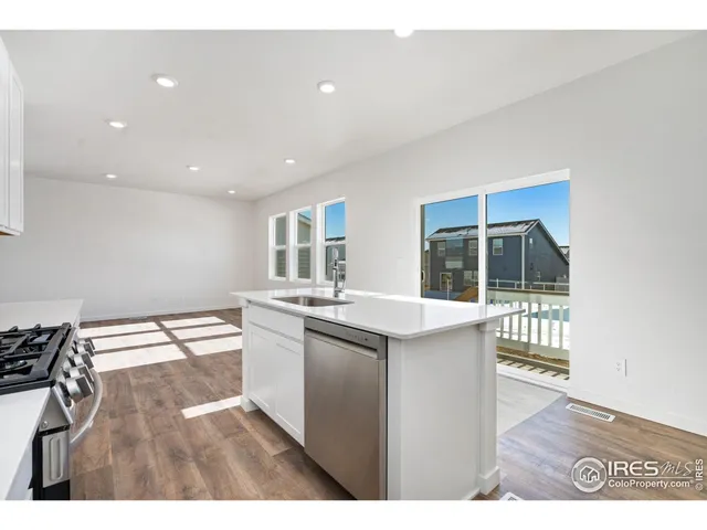 a kitchen with a sink and a stove top oven
