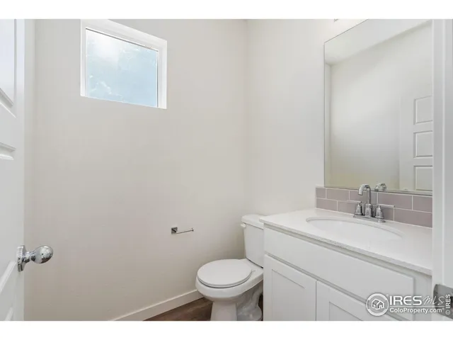 a bathroom with a sink toilet and a mirror