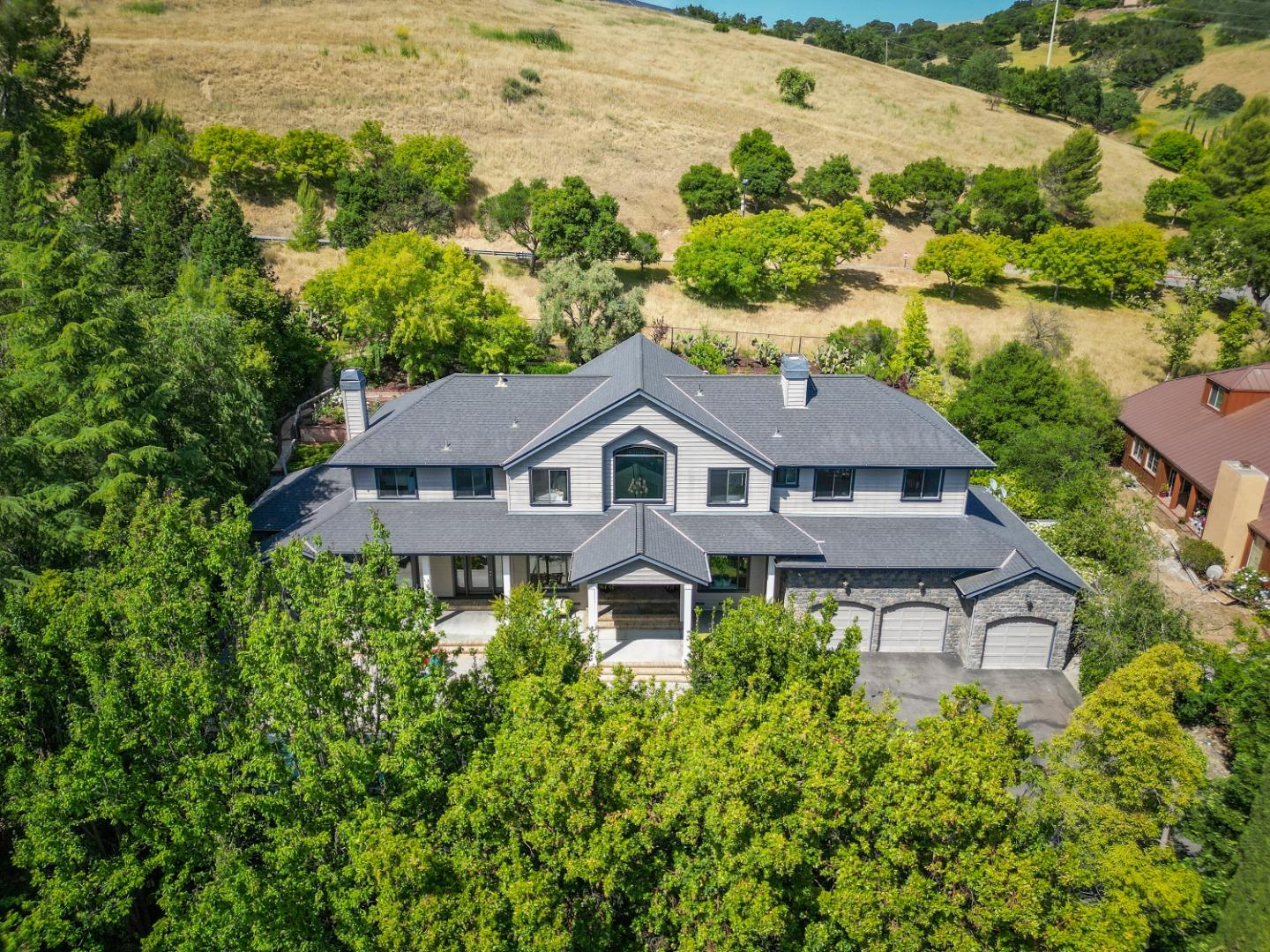 an aerial view of a house with a yard and potted plants