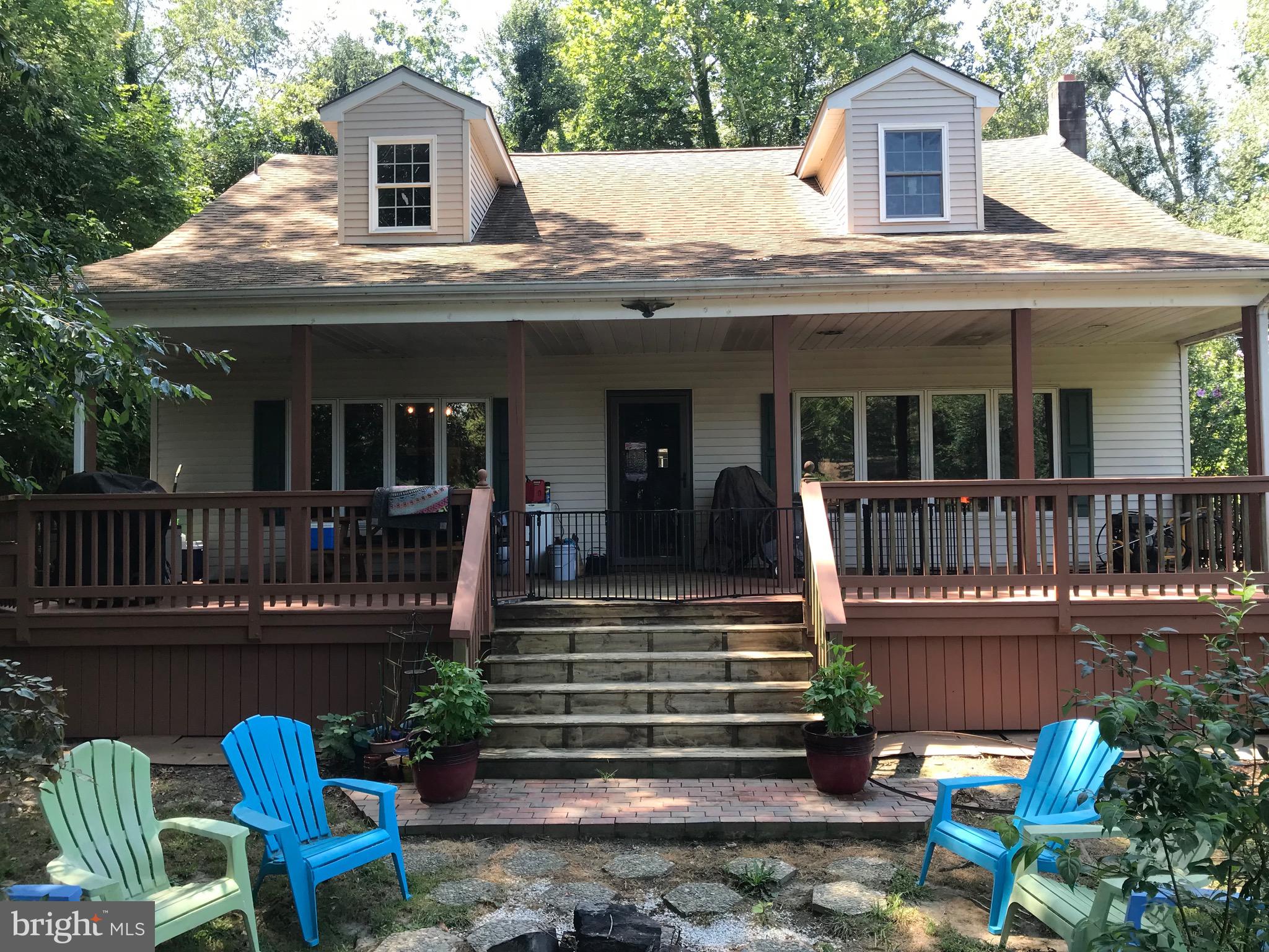a view of a house with a patio and a yard