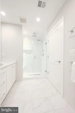 a bathroom with a shower and a sink