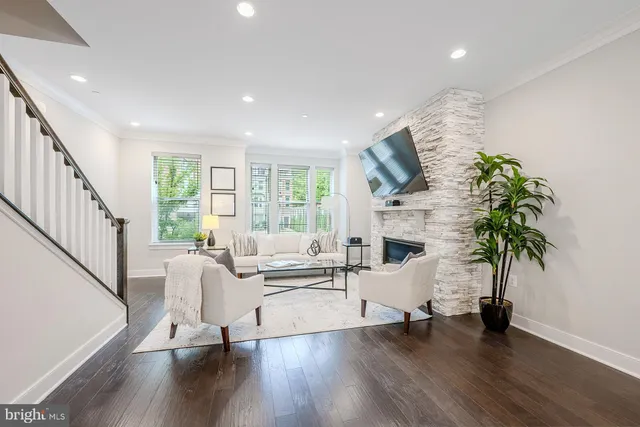 a living room with furniture wooden floor and a flat screen tv
