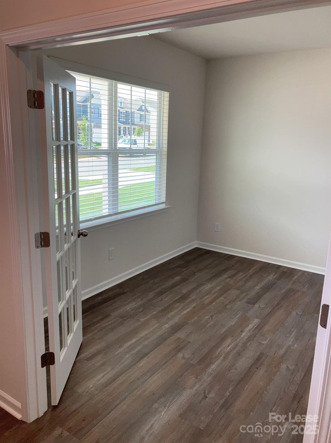 1834 Vanderlyn Street Monroe, NC 28112 - Photo 3 of 18 a view of an empty room with wooden floor and a window