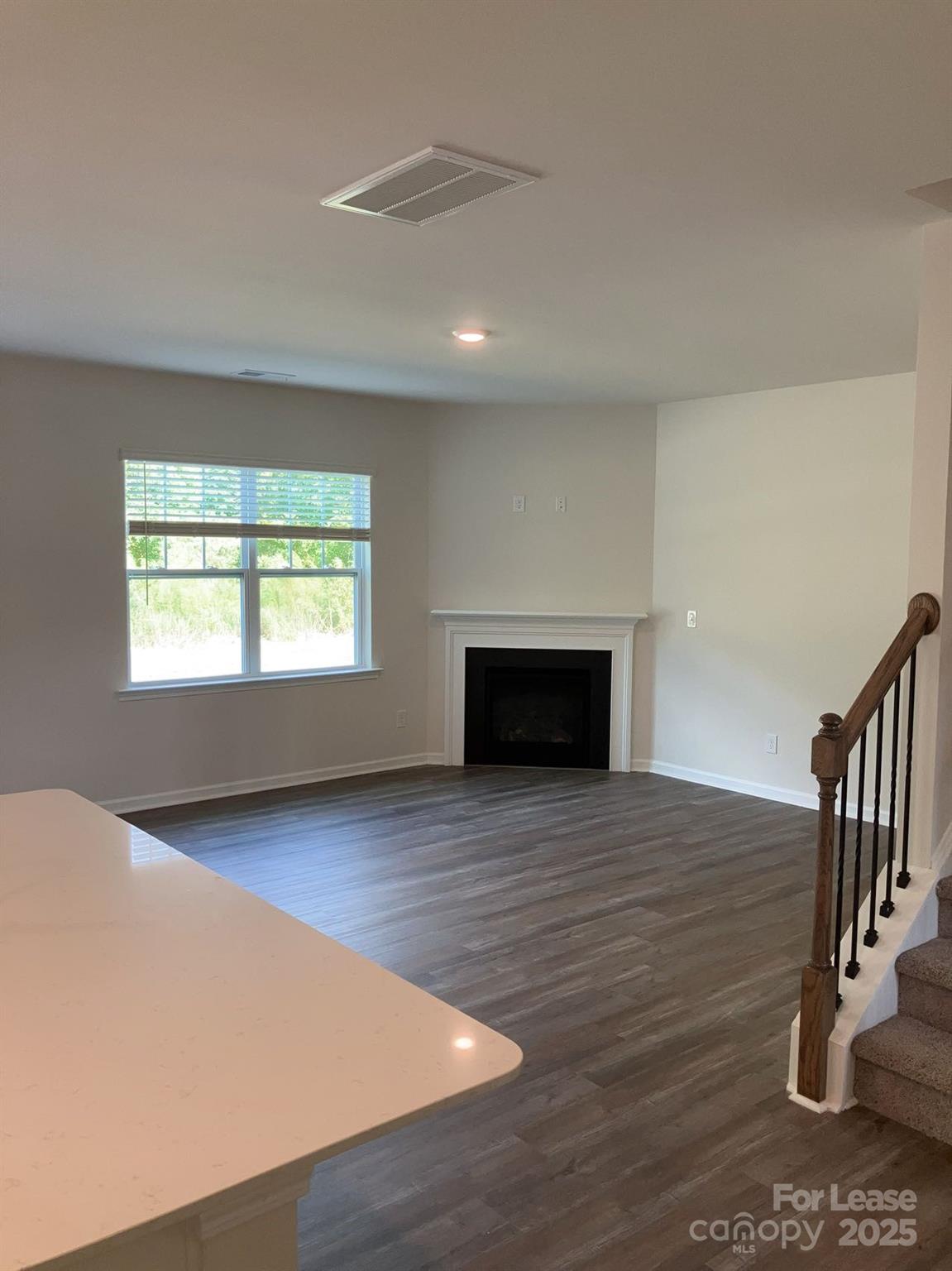 1834 Vanderlyn Street Monroe, NC 28112 - Photo 6 of 18 a view of an empty room with wooden floor and a window