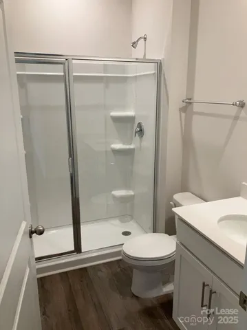 a bathroom with a toilet a sink and a shower