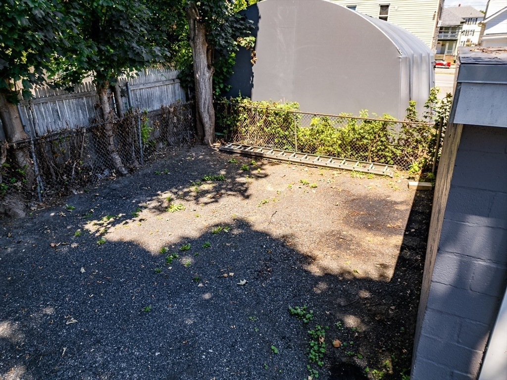 311 South Oxford Street Fall River, MA 02721 - Photo 6 of 11 a view of a yard with wooden fence
