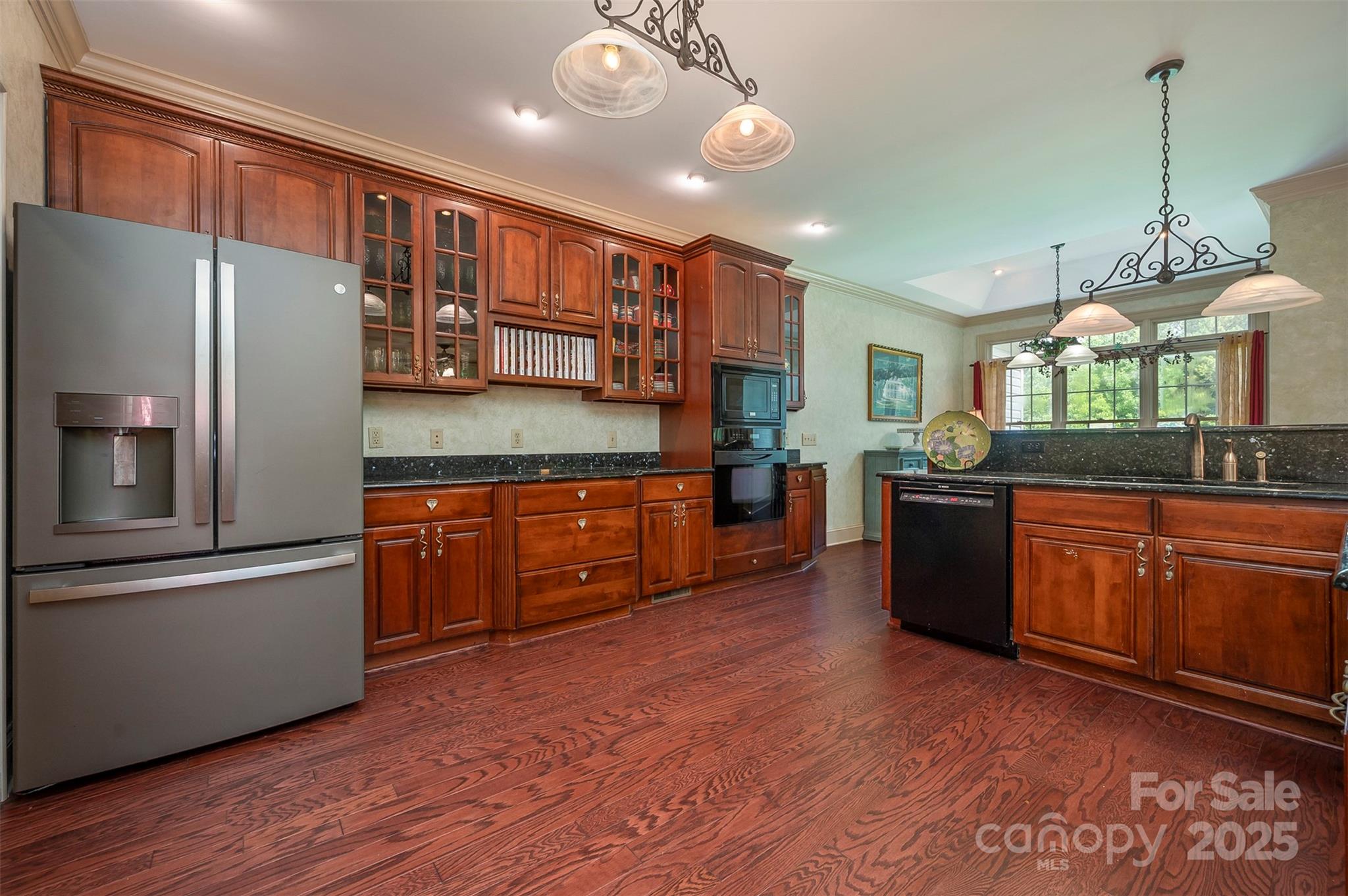147 Pumkin Patch Road Rutherfordton, NC 28139 - Photo 18 of 47 a kitchen with stainless steel appliances granite countertop a refrigerator a sink dishwasher a oven with wooden cabinets and floor