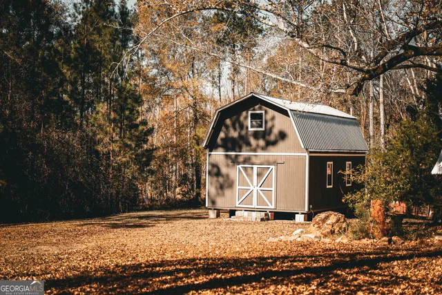 a view of a wooden house with a yard