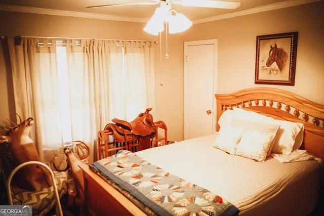 a living room with furniture a flat screen tv and a window