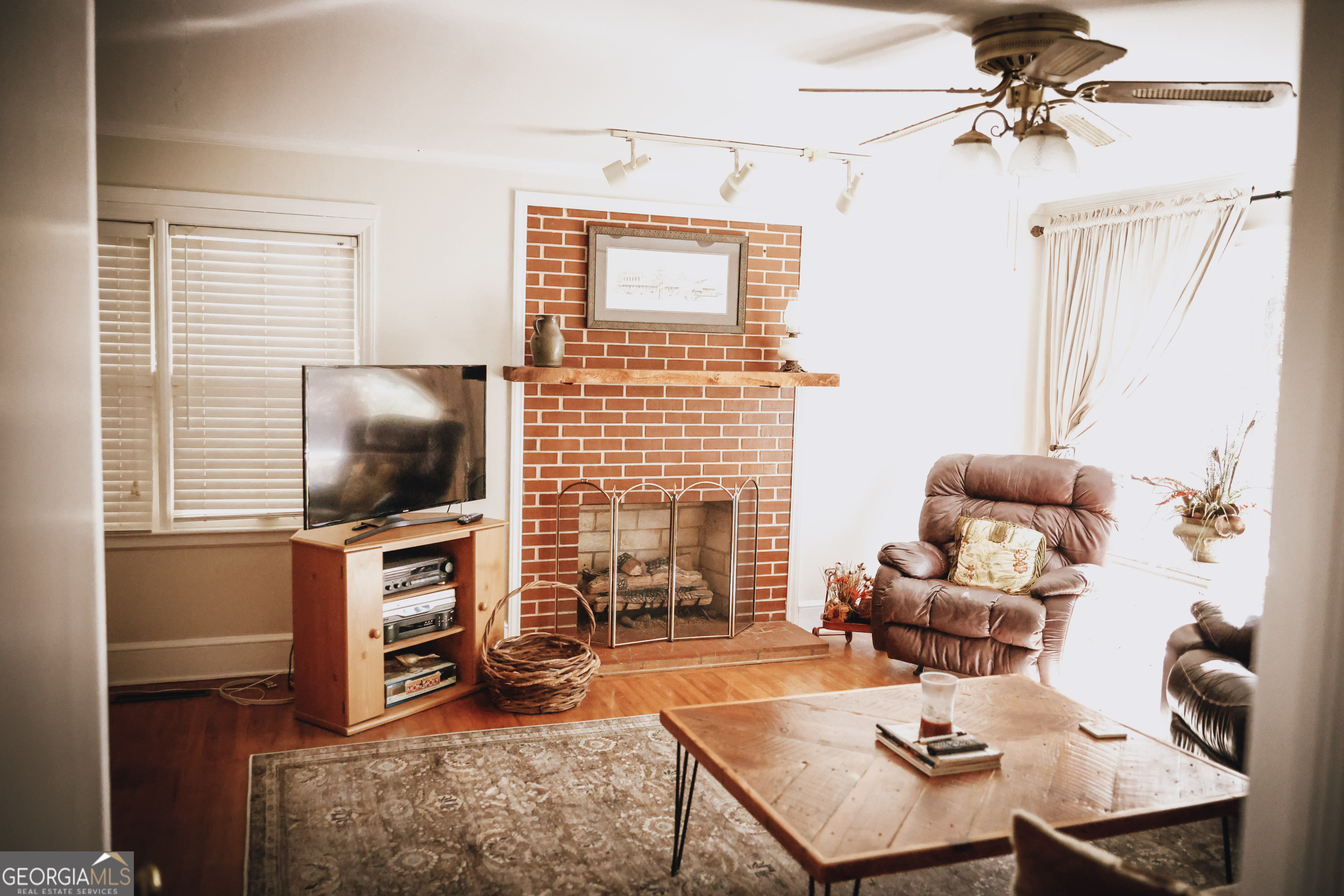 814 Oak Grove Church Road Musella, GA 31066 - Photo 31 of 55 a living room with furniture a flat screen tv and a window