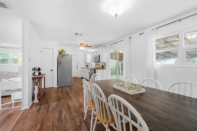 a view of a dining room with furniture window and wooden floor