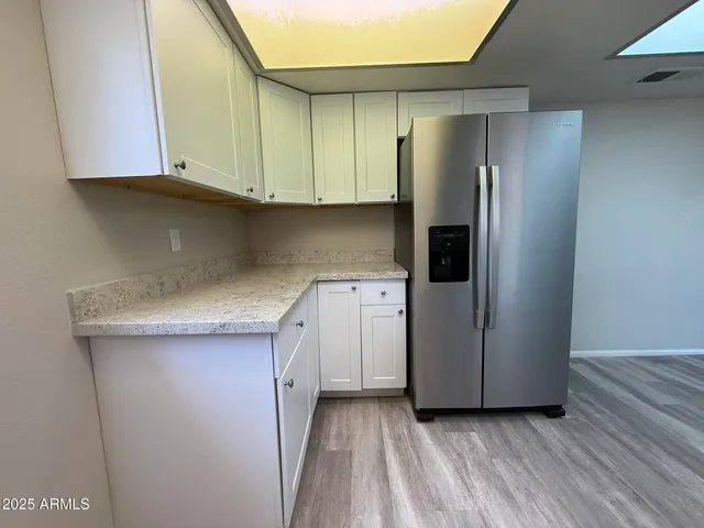 a kitchen with a refrigerator and cabinets
