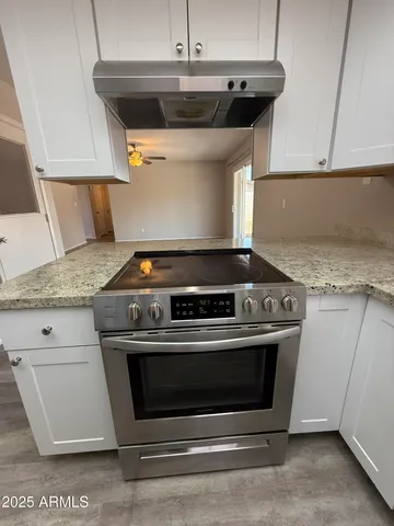 a stove top oven sitting inside of a kitchen