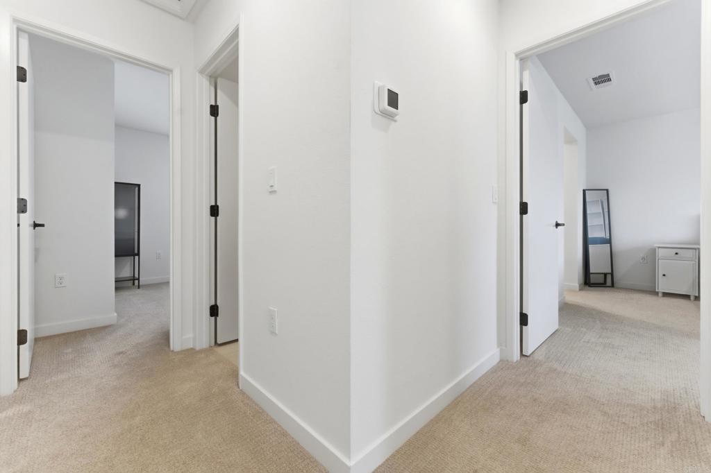35172 Rangpur Lane Fallbrook, CA 92028 - Photo 19 of 47 a view of a hallway with closet and wooden floor