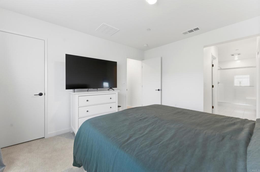 35172 Rangpur Lane Fallbrook, CA 92028 - Photo 23 of 47 a bedroom with a bed and a flat screen tv