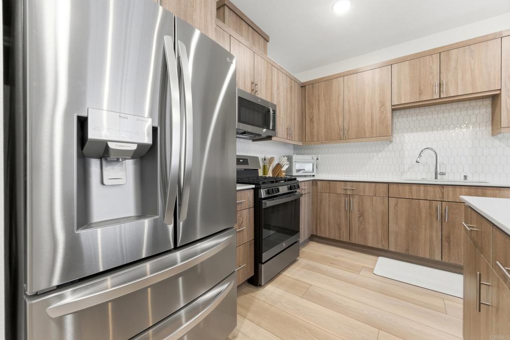 35172 Rangpur Lane Fallbrook, CA 92028 - Photo 5 of 47 a kitchen with stainless steel appliances a refrigerator sink and microwave