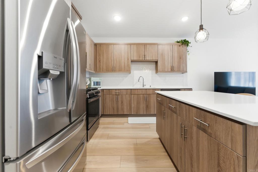 35172 Rangpur Lane Fallbrook, CA 92028 - Photo 6 of 47 a kitchen with stainless steel appliances a refrigerator sink and cabinets