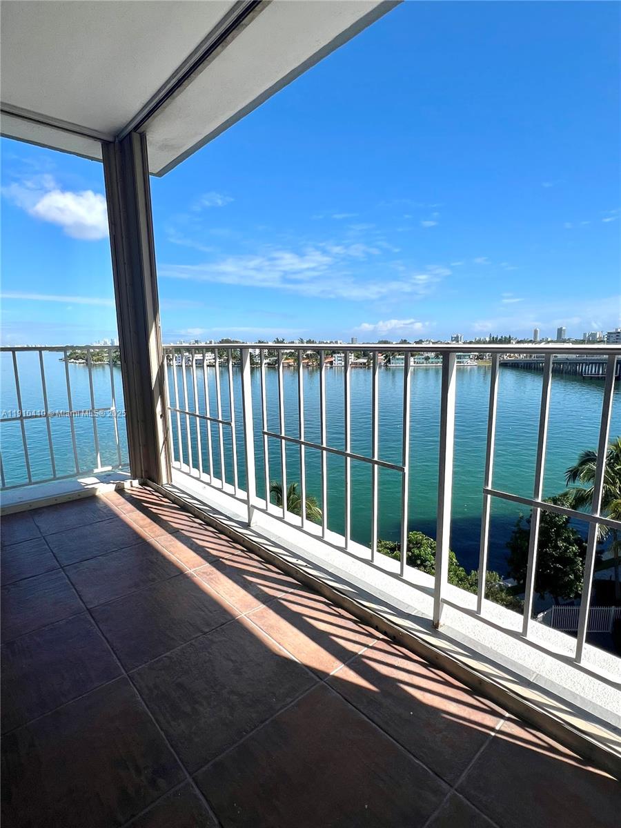 1865 79th Street Causeway, Unit 7I North Bay Village, FL 33141 - Photo 26 of 40 a view of balcony with floor to ceiling window and wooden fence