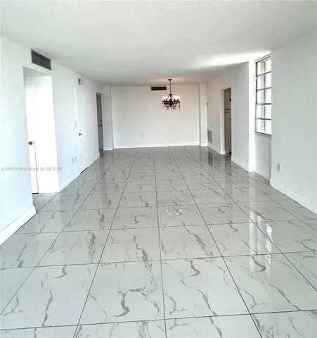 a view of a room with window and chandelier