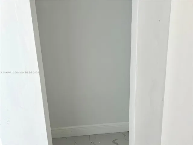 a view of an empty room and floor to ceiling window