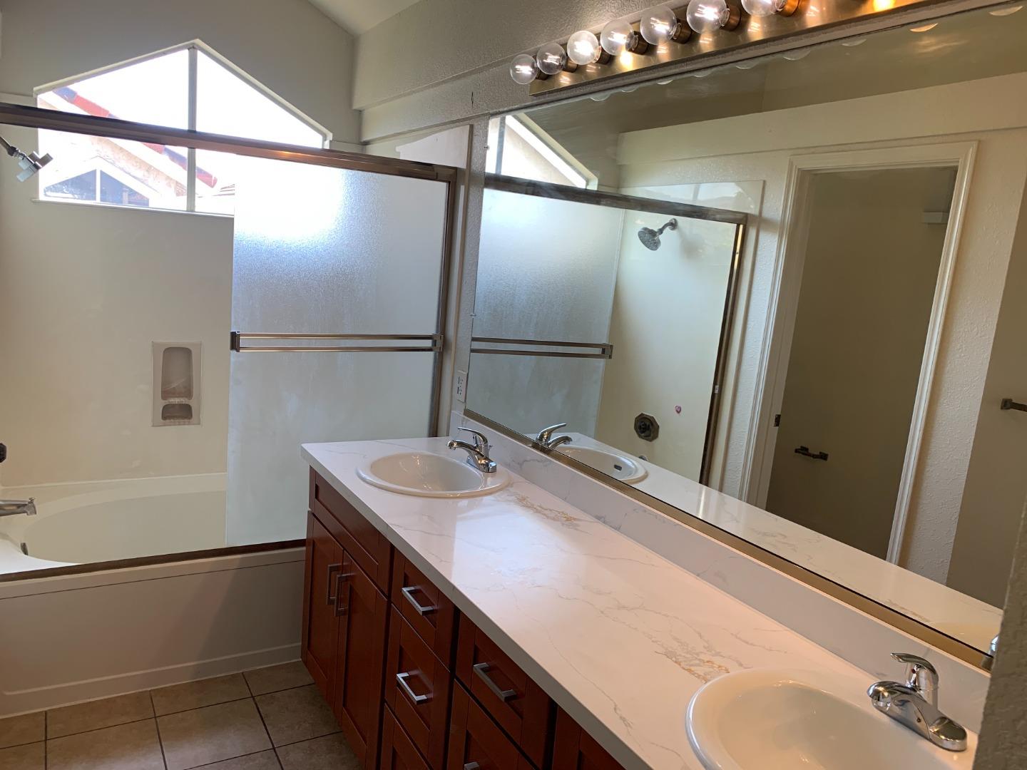 562 Costigan Circle Milpitas, CA 95035 - Photo 15 of 25 a bathroom with a sink double vanity and a mirror