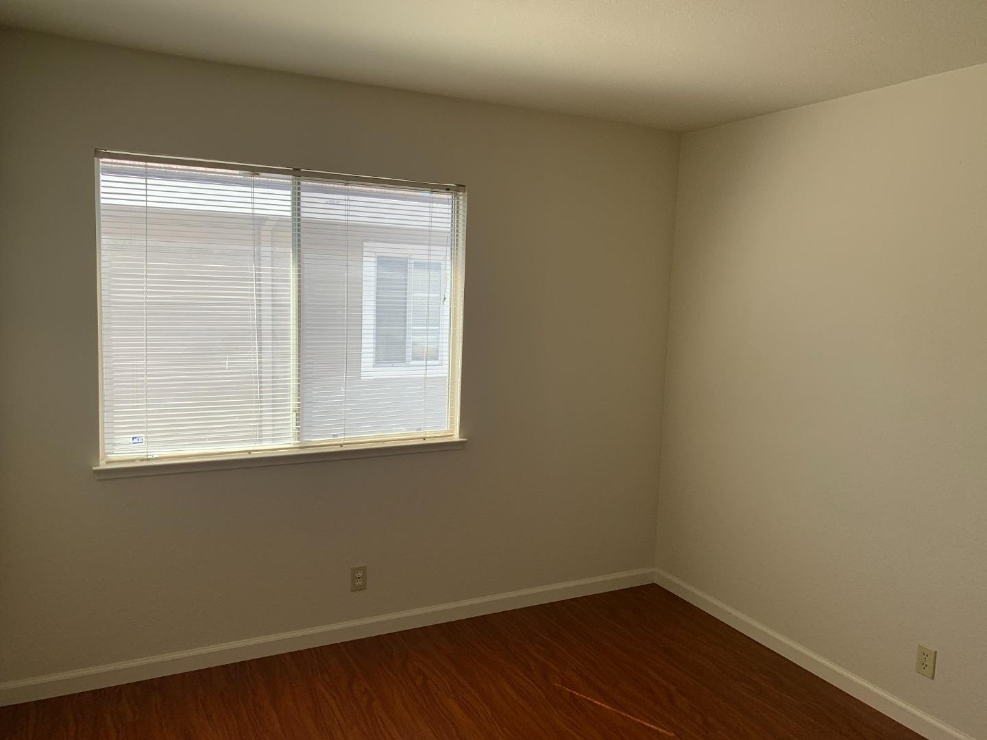 562 Costigan Circle Milpitas, CA 95035 - Photo 18 of 25 a view of a small space with wooden floor and a window